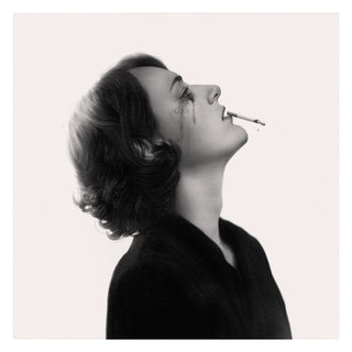 Black and white portrait of a woman in profile with her head tilted back and a cigarette held between her lips, against a plain light background.