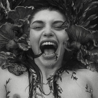Black and white drawing of a woman screaming floating in water