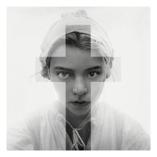 Black and white portrait of a person with a headscarf, focusing on the face.